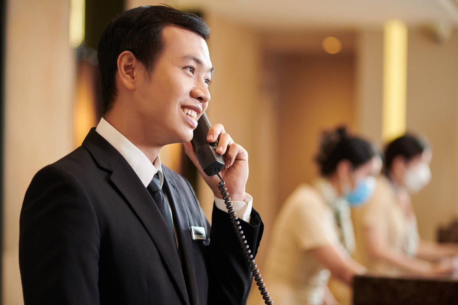 hotel-manager-answering-call-from-guest-2023-11-27-05-35-24-utc-1-1